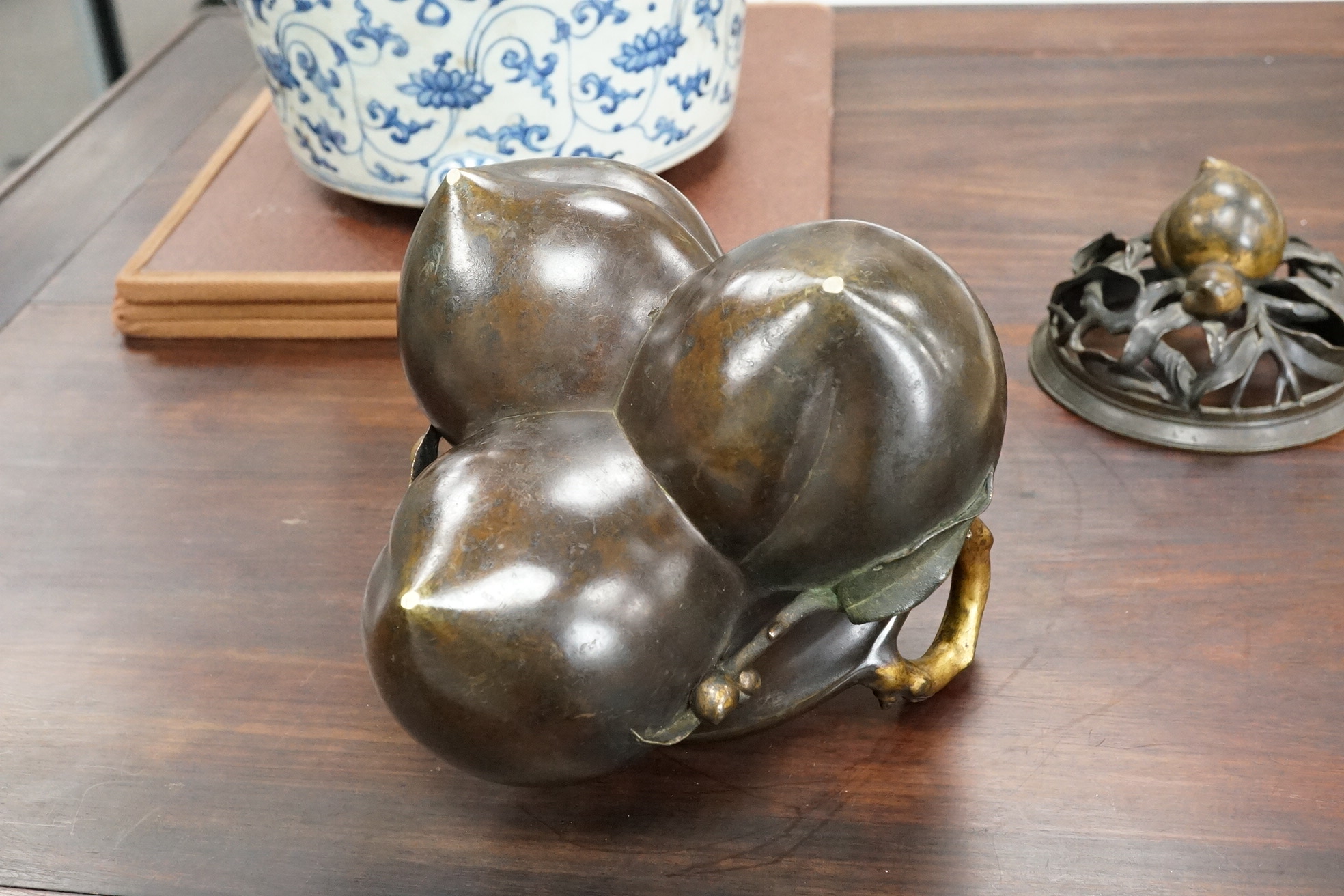 A large Chinese bronze and parcel gilt ‘peach’ censer and cover, Li, 17th/18th century